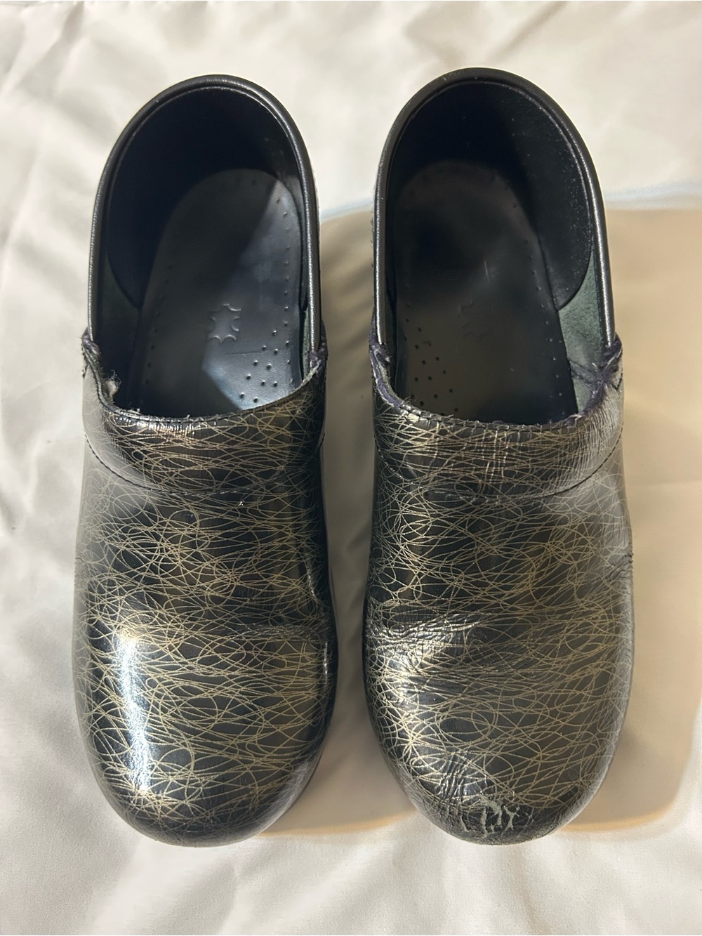 Dansko Black Slip-On Clogs with Metallic Gold Threaded Pattern